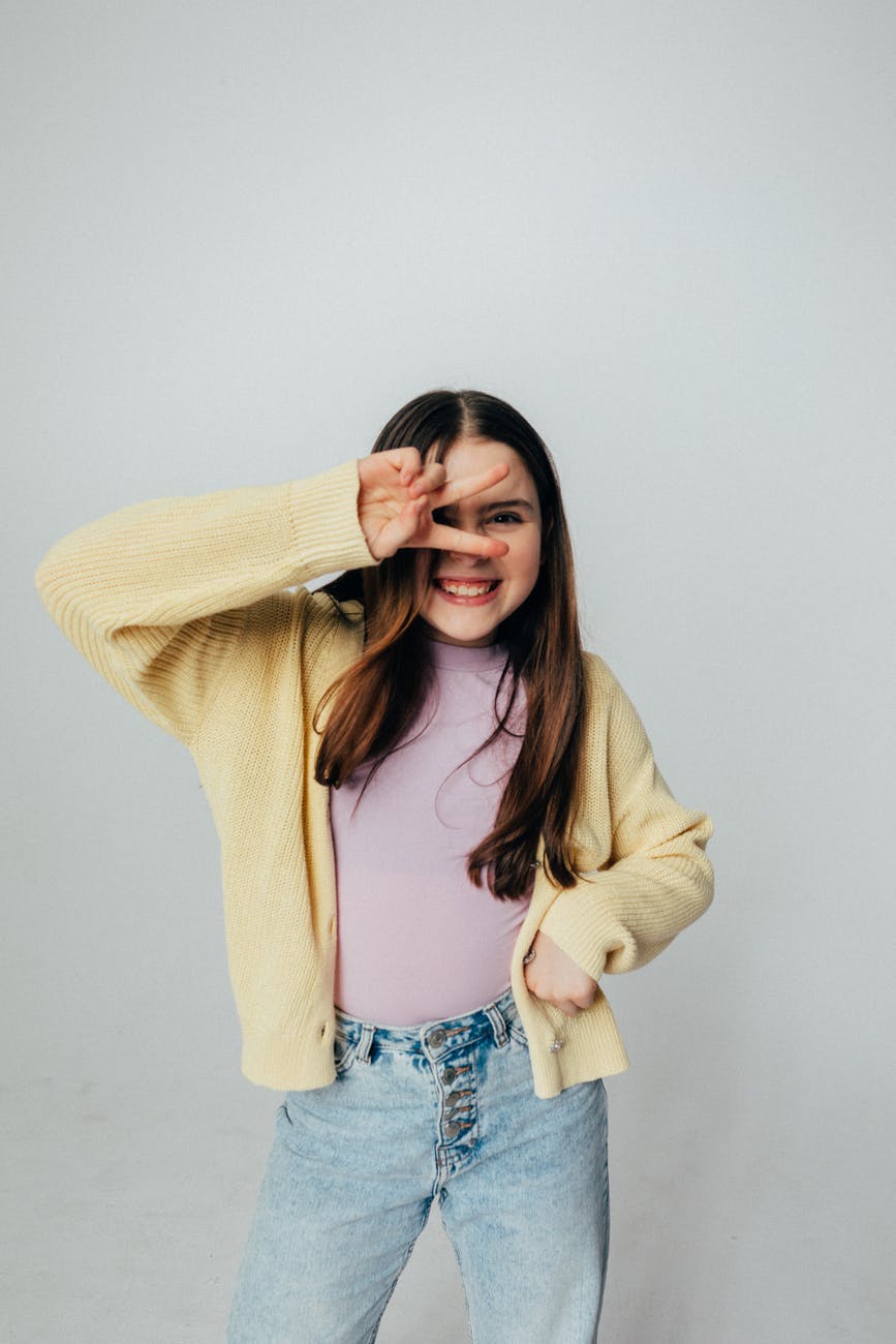 girl in yellow sweater and denim jeans